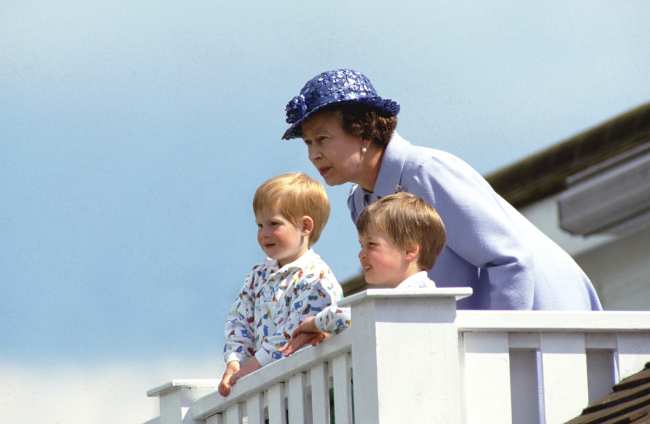              Prince Harry is seen with his brother Prince William and their late grandmother Queen Elizabeth II in June 1987             