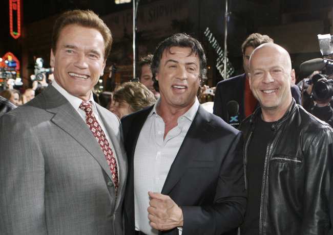              Arnold Schwarzenegger Sylvester Stallone and Bruce Willis pose during the Rocky Balboa world premiere in Hollywood Calif in 2006             