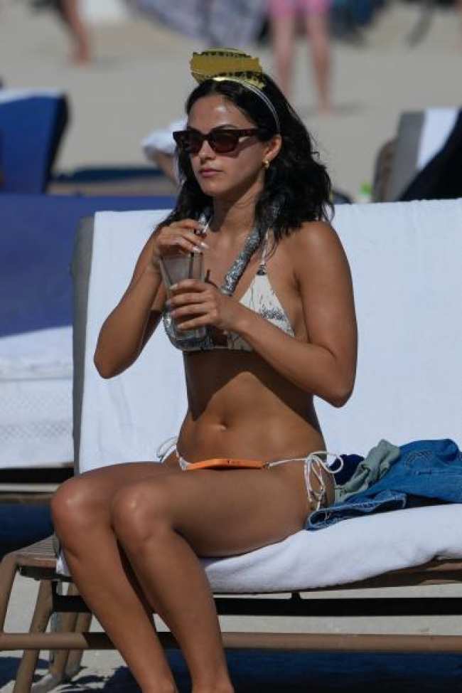 Camila Mendes sentada en una tumbona en la playa
