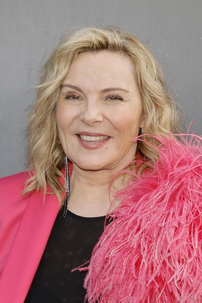 Kim Cattrall con una chaqueta rosa de plumas