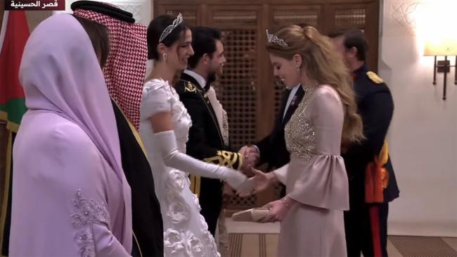 La realeza sonrió mientras saludaba a la novia, que lució una floreciente creación de Dolce & Gabbana para su recepción.