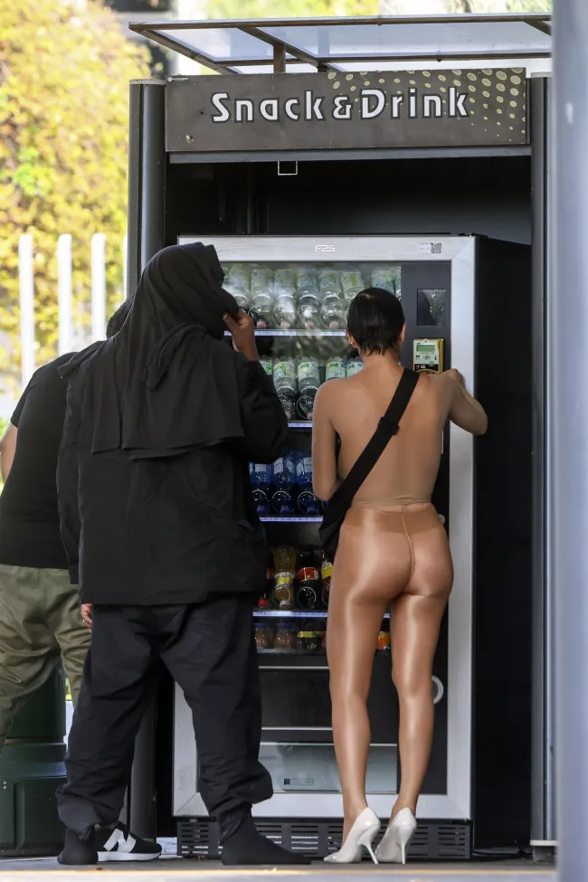 Censori se puso su conjunto de medias transparentes mientras tomaba una bebida de una máquina expendedora.