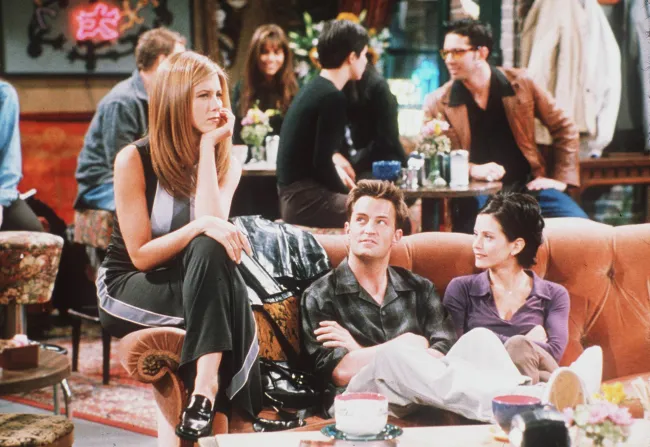 Jennifer Aniston, Matthew Perry y Courtney Cox en el sofá naranja en 'Friends'