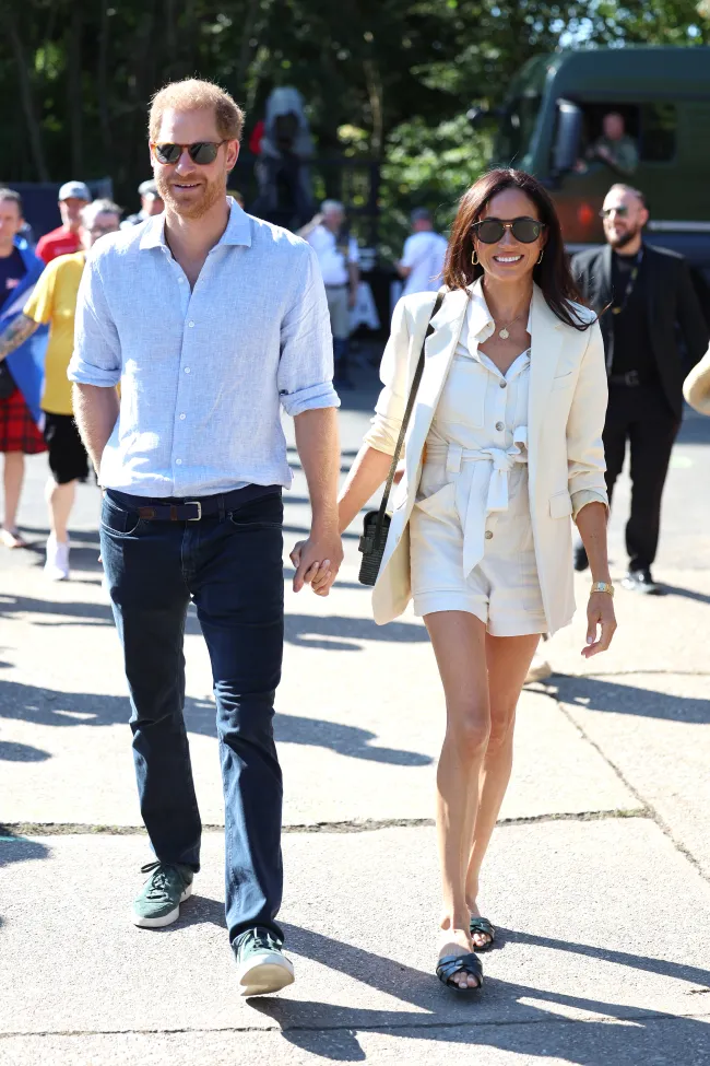 El príncipe Harry y Meghan Markle tomados de la mano caminando