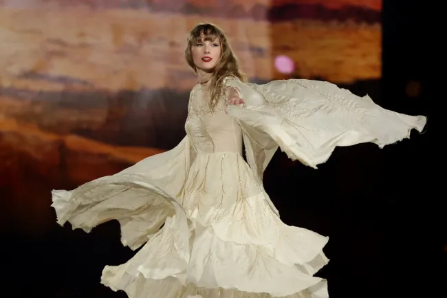 Taylor Swift actuando con un vestido fluido.