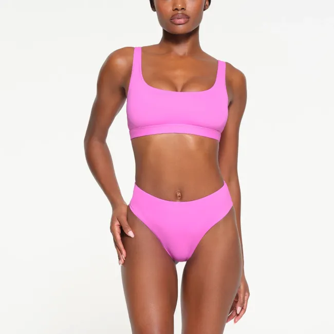Una modelo en bikini rosa.