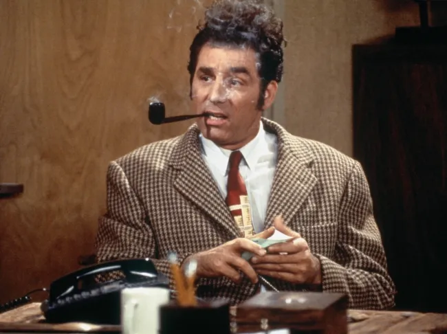 Michael Richards como Cosmo Kramer