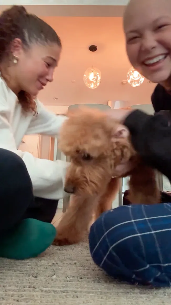 Isabella y Sophia Strahan jugando con su perro.